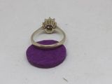 a close up of a ring on a purple felt surface