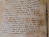 an old book with writing on it sitting on a table