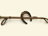 a close up of a horse shoe hook on a white background
