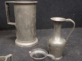 four different types of pewware on display in a glass case