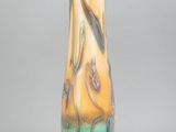 a glass vase that is sitting on a stand