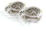 pair of diamond and pearl earrings on a white background