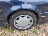 a close up of a blue car with a flat tire