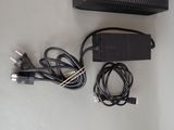 a black box with wires and a charger on a table