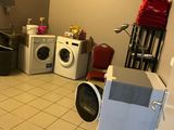 an image of a laundry room with a washer and dryer