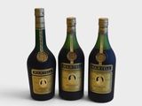 three bottles of wine sitting next to each other on a white surface
