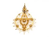 gros plan d'un pendentif en or sur fond blanc