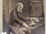 an old photo of a man sitting at a desk