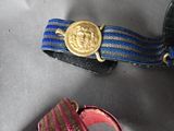 a blue and gold belt with a gold medallion on it