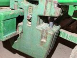 a close up of a green tractor with a large wheel