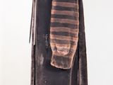 an image of a brown and black striped coat on a mannequin stand