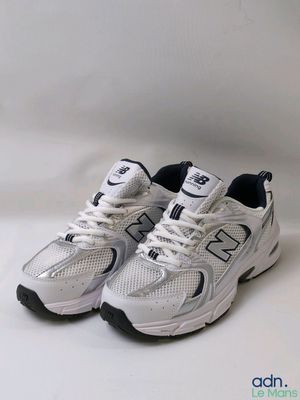 the new balance 991 is a white sneak with black accents