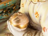 a figurine of a man holding a ball on a table