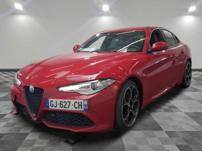the red alfa car is parked in a large room
