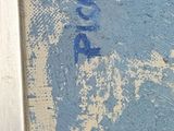 a close up of a painting on the floor of a public restroom