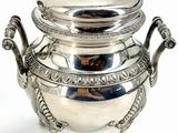 an antique silver plated teapot with a lid on a stand