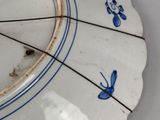 a white plate with blue designs on it on a table
