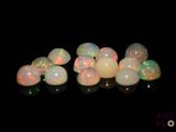 some white and pink oplites sitting on top of a black surface