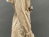 an image of a mannequin mannequin wearing a beige trench coat