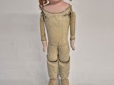 a small doll that is standing on a white surface