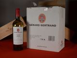 a bottle of wine sitting next to a box on a table