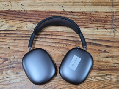 an image of a pair of headphones sitting on top of a wooden table