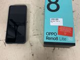an open box of a black cell phone sitting on top of a table