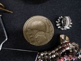 a gold coin sitting next to a pair of scissors and a pair of scissors