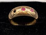 an image of a gold ring with rubies on it