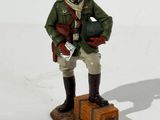 a figurine of a soldier standing on a box