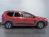 a red toyota rav parked in a room with a white wall