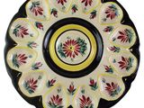 a close up of a plate with a flower design on it