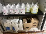 many bottles of liquid sitting on a shelf next to boxes