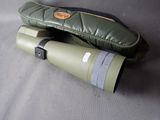 a pair of binoculars sitting on a table next to a pair of mittens