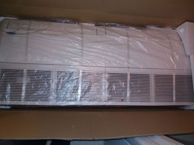 a air conditioner sitting on top of a cardboard box