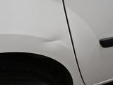 a white car that is parked on the side of the street