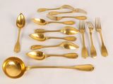 a lot of gold colored spoons and spoons on the table