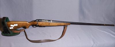 a rifle that is sitting on a white surface