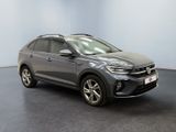 a grey volkswagen suv parked in a room with a black floor