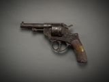 an old gun on a gray surface with a black background