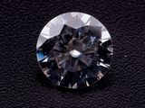 a close up of a diamond on a black surface