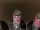 several bottles of wine are lined up in a row on a table