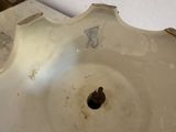a white sink with a hole in the middle of it