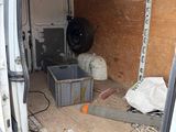a white van that has a lot of stuff in the back of it