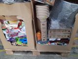 a cardboard box filled with many different items on a pallet