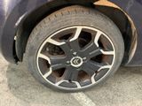 a close up of a tire on a blue car
