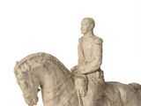a statue of a man riding a horse on a white background