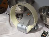 a silver mixer and a silver bowl on a table
