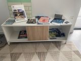 a table with books and magazines on it in a room