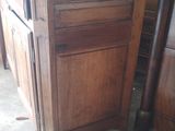 a wooden cabinet with a marble top in a room